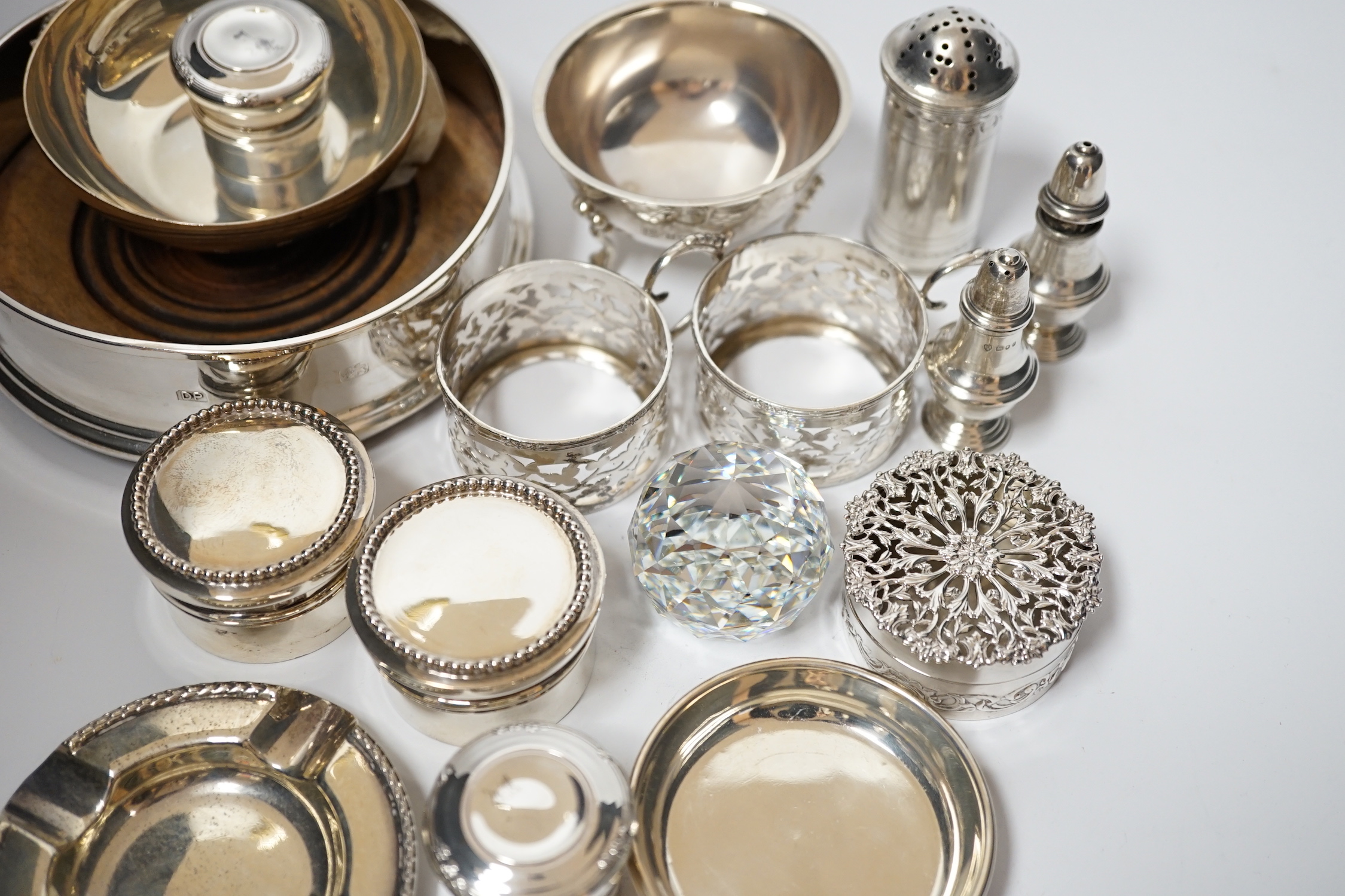 A small collection of sundry small silver including modern silver mounted wine coaster, coffee can holders, salt, taste vin, pot pourri box, pill boxes, Georgian pepperette, small dishes etc.
